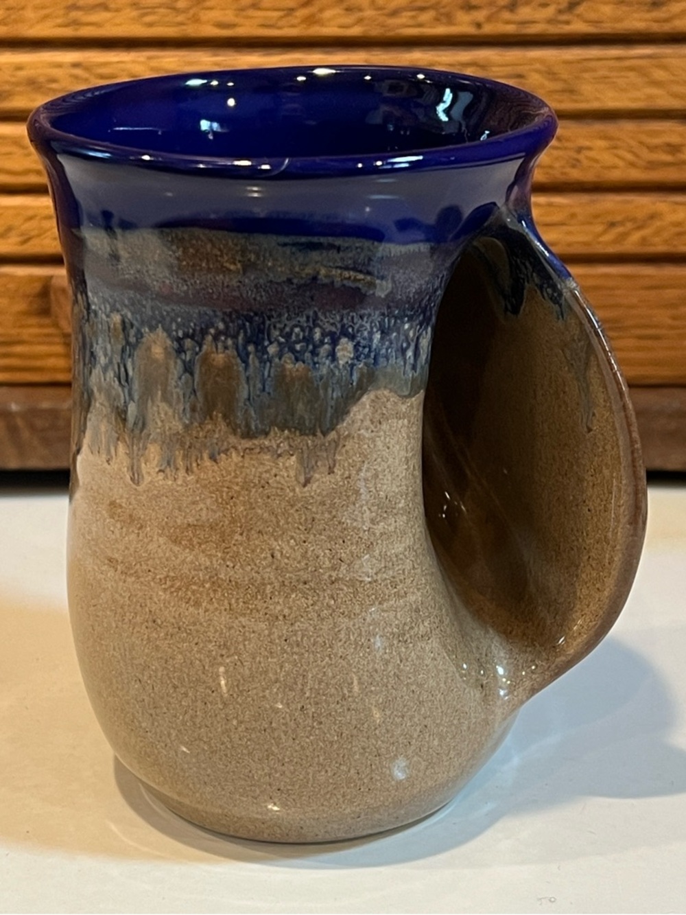 Handwarmer Mug by Clay in Motion, cobalt canyon glaze. Side pocket warms hands.